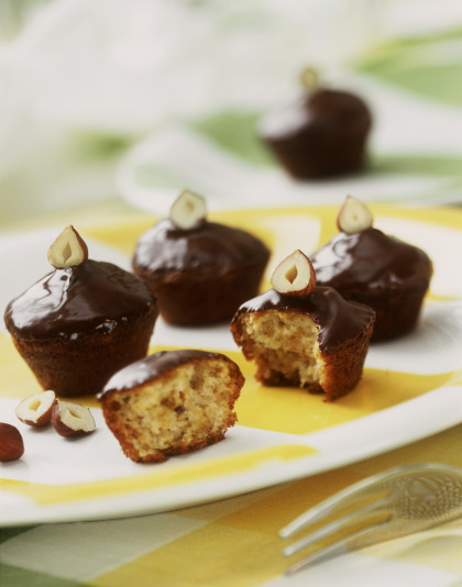 Cognac muffins with chocolate icing and hazelnuts