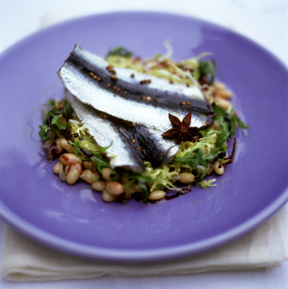 Pickled herring fillets on bean salad