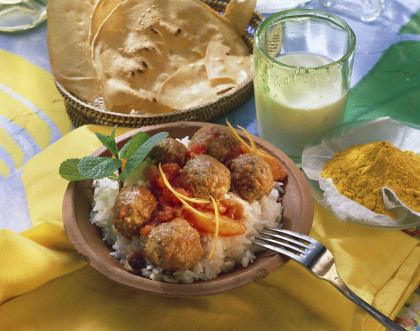 Indian meat balls with a tomato-orange sauce on rice