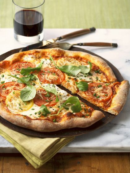 Pizza Margherita with red and yellow tomatoes and basil