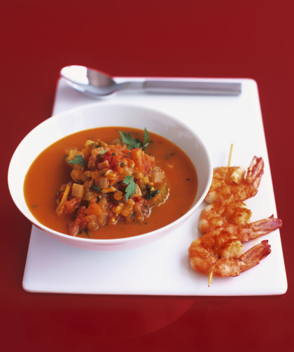 Tomato lentil and chilli soup with fried prawn skewer