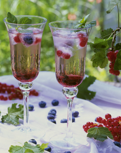 Blackcurrant champagne cocktail with berries