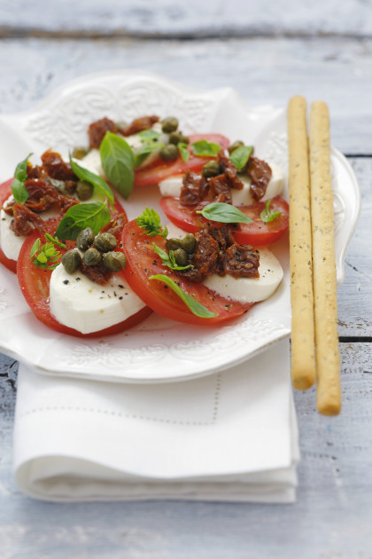 Mozzarella and tomatoes with dried tomatoes, capers, grissini