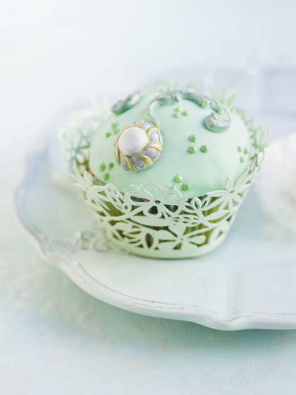Cupcake with bright green icing and decorating