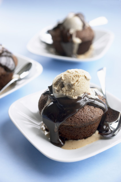 Warm chocolate volcano cakes with ice cream and chocolate sauce