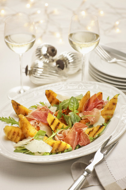 Grilled melon with prosciutto ham on a rocket and parmesan salad for Christmas