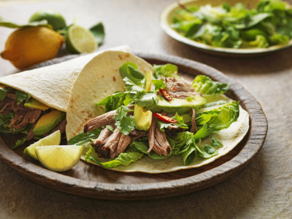 Wraps filled with pork, lettuce, avocado and chillies