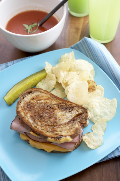 Grilled Ham and Cheese Sandwich with Chips and a Pickle