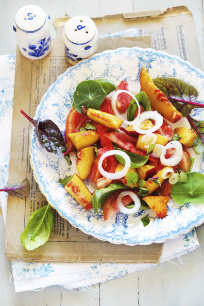 Summer peach and tomato salad with nasturtium and chard leaves