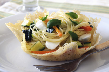 Gluten-free Pasta primavera in a Parmesan basket