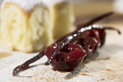 Bavarian yeast-raised pastry with icing sugar, preserved plums and vanilla pods