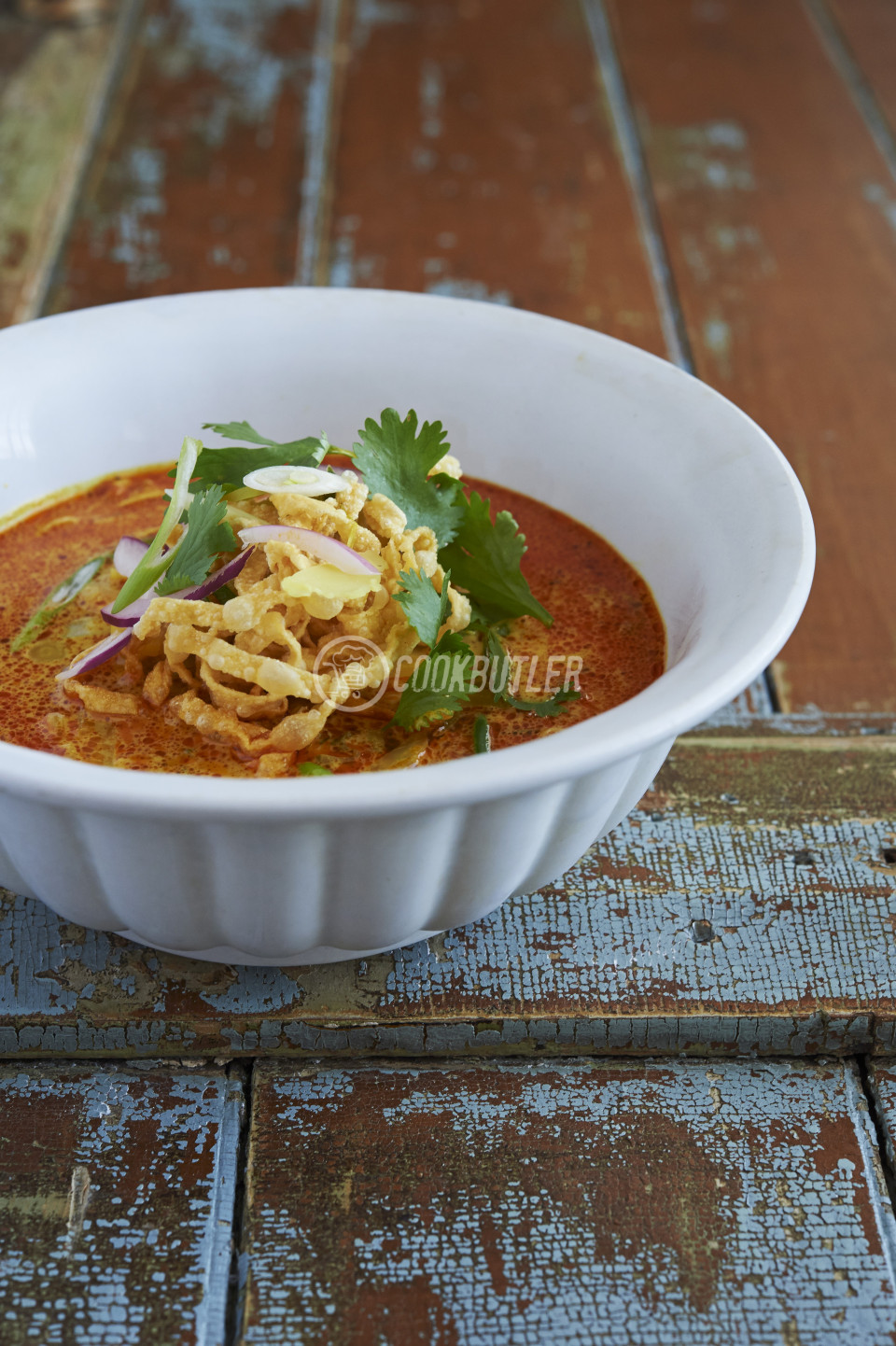 Khao Soi noodle soup with coconut milk, yellow curry, coriander, onion and crispy noodles (Thailand) | preview