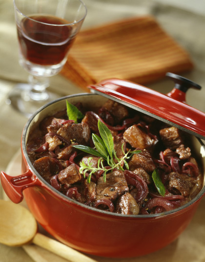 Casserole dish of beef stew cooked with wine and onions