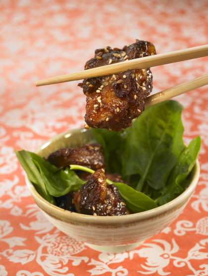 Sweet and sour pork with sesame seeds and spinach shoots