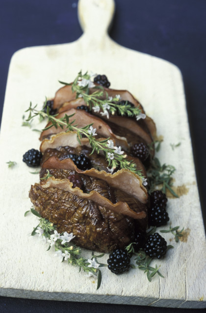 Roast beef with bacon, thyme in flower and blackberries