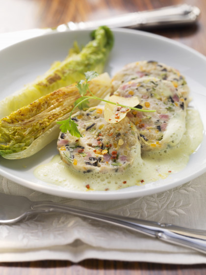 Saumagen with pan-fried lettuce and lemon sauce (sausagemeat speciality of the Palatinate region)