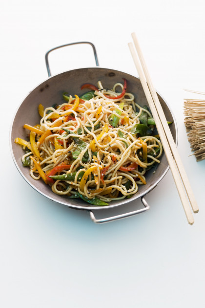 Asian noodles with colourful vegetables cooked in a wok