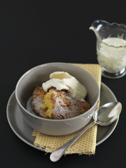 Baked lemon and coconut pudding with vanilla ice cream