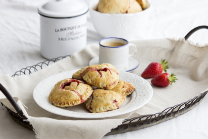 Hand pies (mini pies) with a strawberry filling and heart decorations (gluten-free)