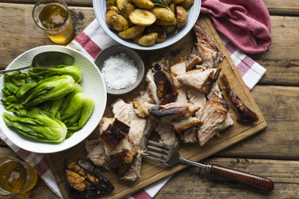 Roasted pork belly with rosemary potatoes, bok choy and beer
