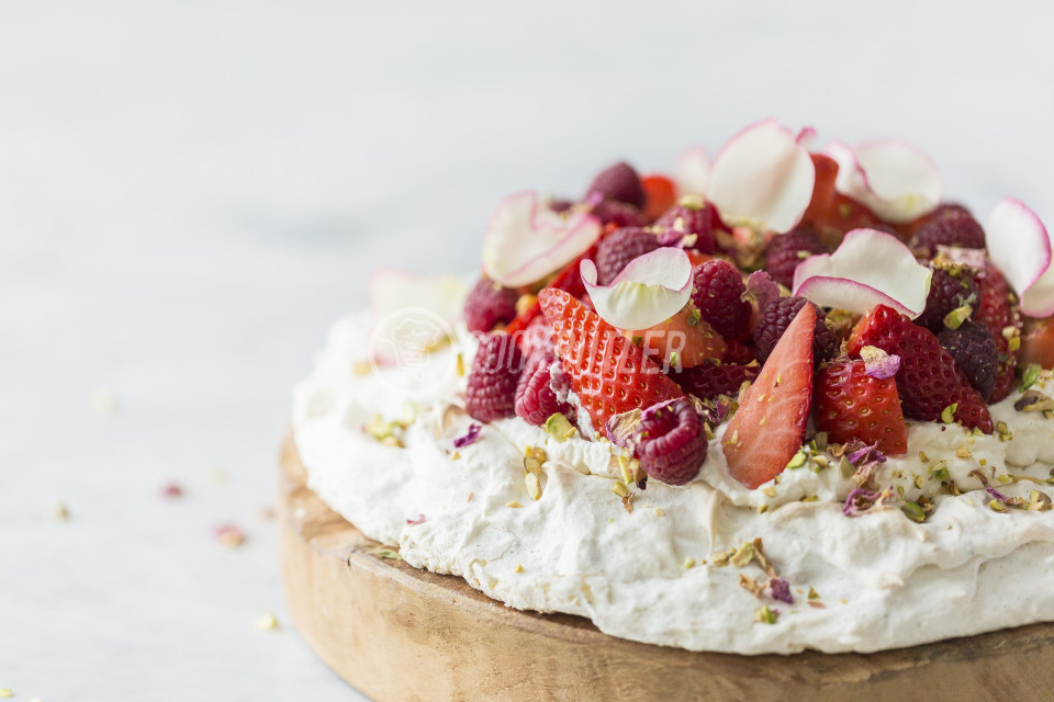 Rose and pistachio pavlova with fresh strawberries and raspberries, with pistachio nuts | preview