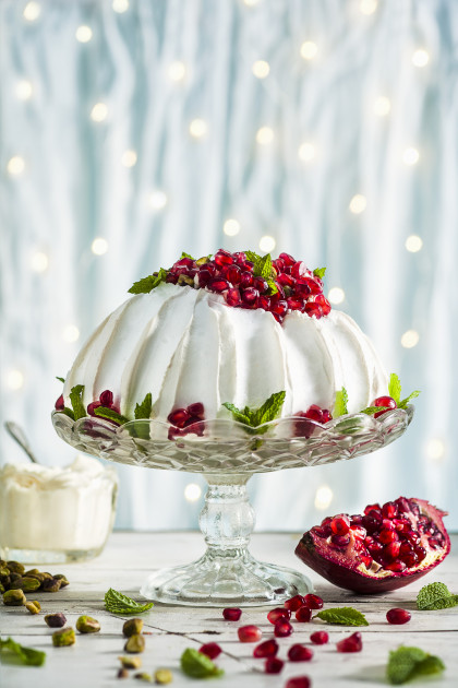 Pavlova with pomegranate seeds and pistachio nuts for Christmas