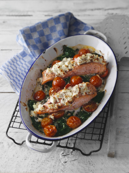 Oven-baked salmon with a feta cheese crust, spinach and cherry tomatoes