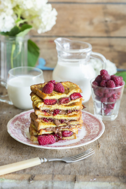 French toast with hazelnut and chocolate spread and fresh raspberries, with milk (gluten-free)