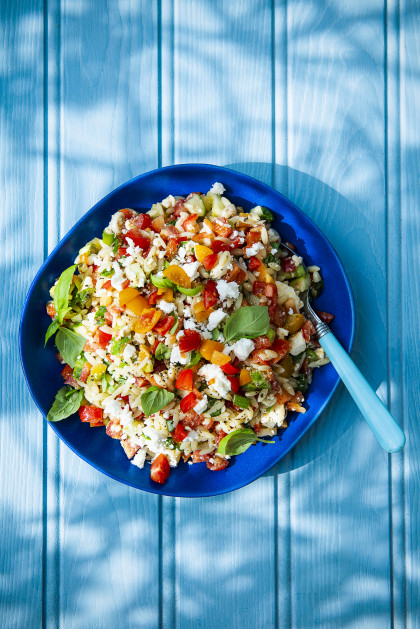 Summer orzo pasta, feta cheese, basil, tomatoes and peppers salad with olive oil