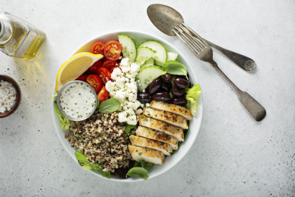 Greek inspired lunch bowl with grilled chicken, quinoa, feta and vegetables