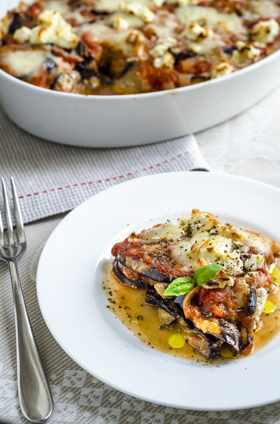 Parmigiana di melanzane with tomatoes, mozzarella, oregano, olive oil, basil and ricotta | preview