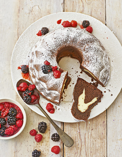 Chocolate ring cake with cream cheese filling and berry compote