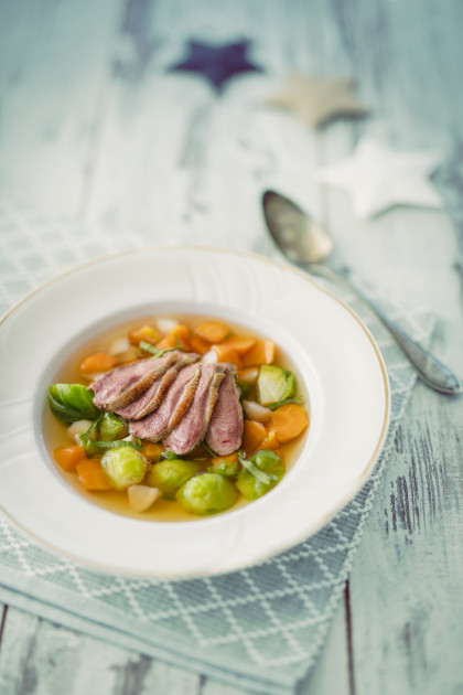 Poultry consomme with carrots and Brussels sprouts for Christmas