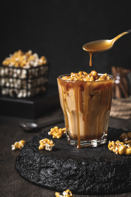 Homemade coffee with caramelized popcorn and salted caramel sauce