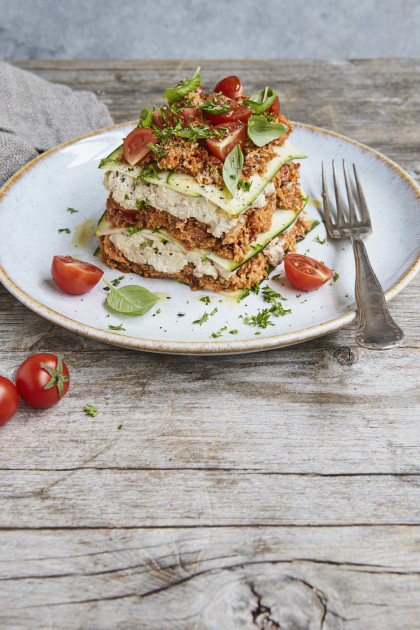 Garden lasagne with courgette, cashew cream, minced sunflower seeds and tomatoes