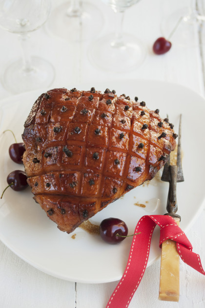 Glazed ham with cloves and cherries for Christmas