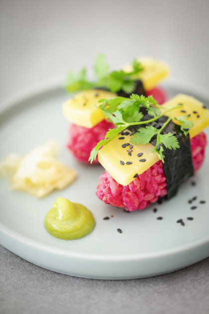 Vegan nigiri sushi with beetroot rice, yellow beetroot, nori and coriander