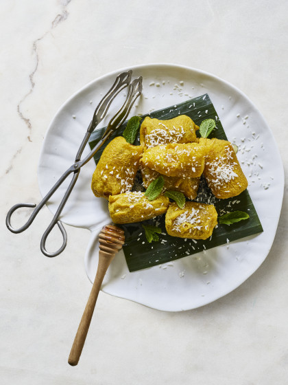 Banana fritters with honey coated in coconut