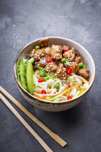 Asian style noodles with teriyaki chicken, vegetables and green peas pods