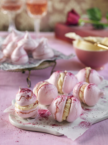 Pink meringues with frosting and raspberry powder for Valentines day