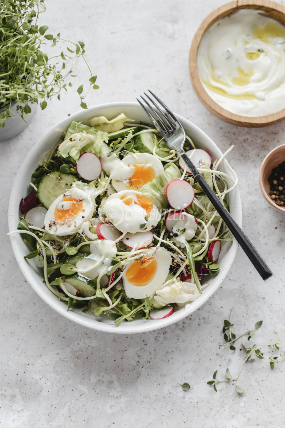 Salad with cucumber, radish sprouts, eggs and yogurt dressing | preview